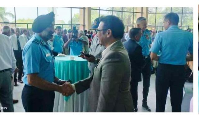 A handshake between a team member and an officer in uniform at a veterans gathering