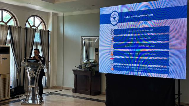 Large screen displaying eligibility, interest and deposit limits for a senior citizens pension scheme