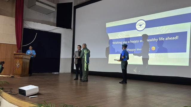 Felicitation moment on stage at an Air Force auditorium