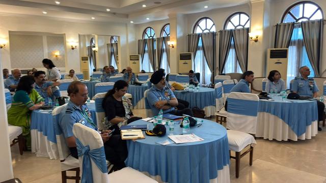 Officers and family members seated at round tables during an investor awareness seminar