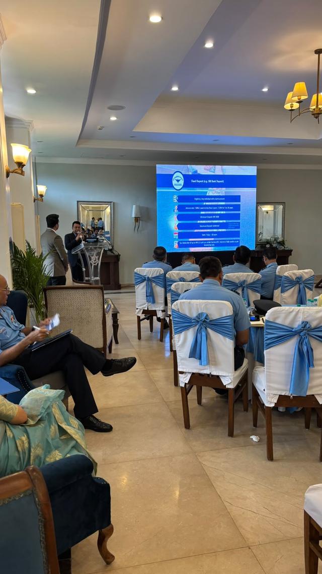 Speaker at the podium explaining fixed deposit features on screen
