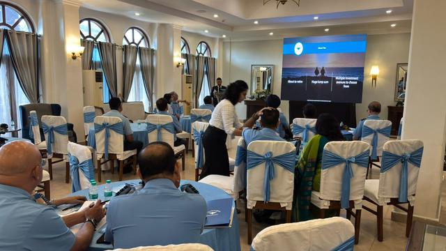 A team member assisting attendees at their seats during a seminar