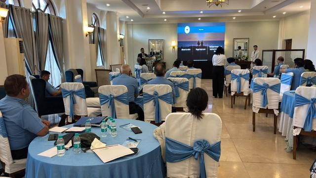 Seminar hall with a presentation screen showing retirement planning topics